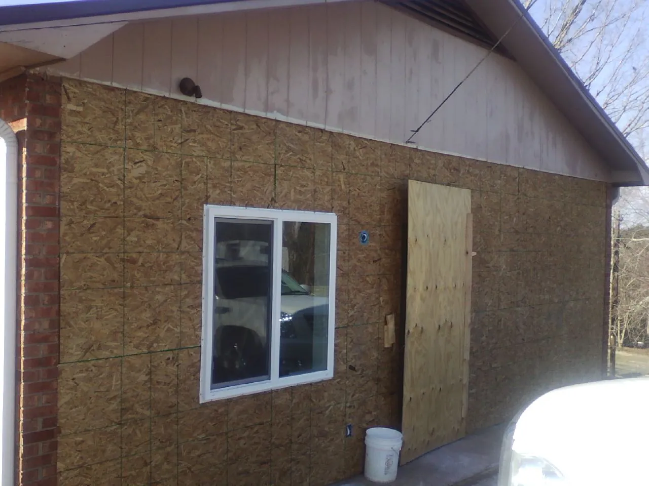 OSB sheathing on a garage addition wall before siding in Sugar Grove