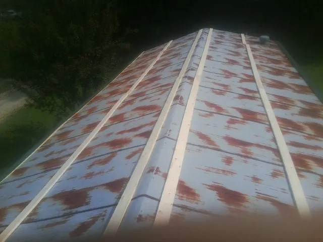 Rusted metal roof panels with new wood purlins before replacement — Storm Damage Roof Repair in Sugar Grove by Roofing Brothers